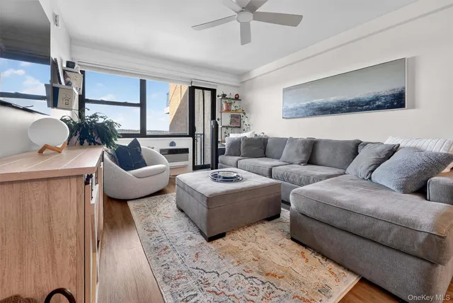 a large bedroom with a large bed a potted plant a fireplace and a window