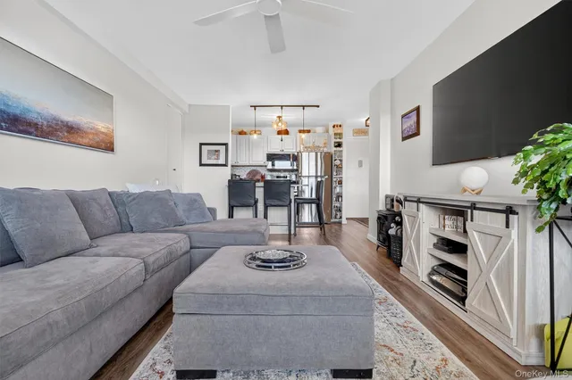 a living room with furniture a rug and a chandelier