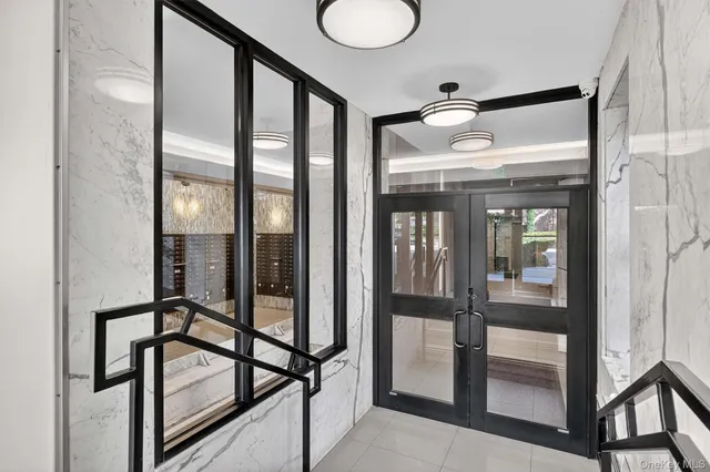 a view of an empty room with stairs and a window