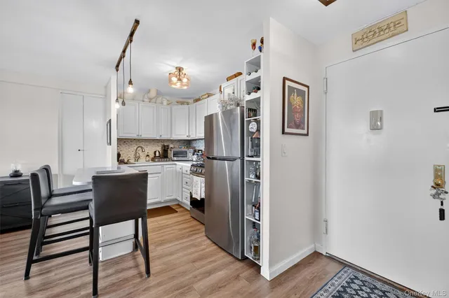 a kitchen with stainless steel appliances a refrigerator sink and cabinets