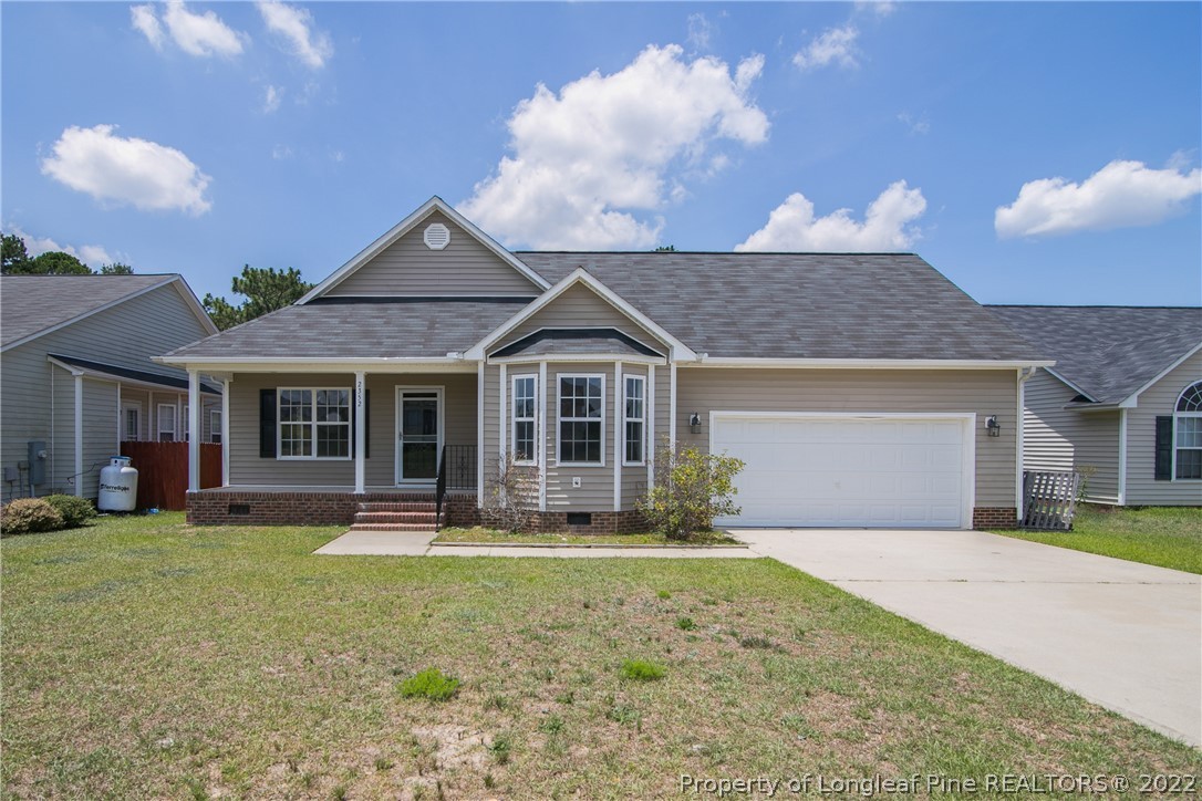 2352 Saltwood Road Fayetteville, NC 28306 - Photo 1 of 2 a front view of a house with a yard and porch