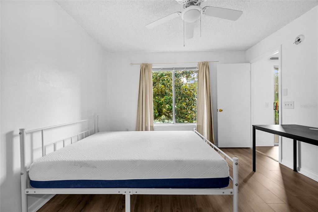 3921 Southwest 34th Street, Unit 208 Gainesville, FL 32608 - Photo 23 of 33 a bedroom with a bed and a chandelier