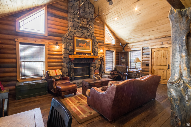 18906 North Canyon Road Whiterocks, UT 84085 - Photo 6 of 65 Living area featuring high vaulted ceiling, a fireplace, dark wood-type flooring, wooden ceiling, and log walls