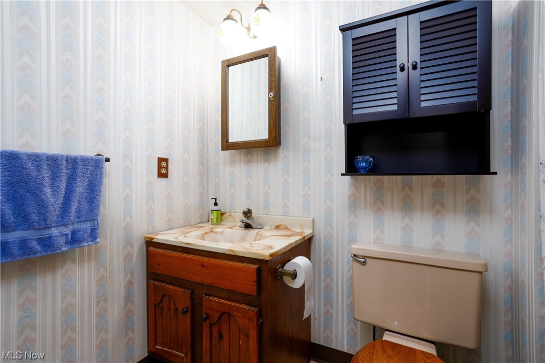 5680 Lance Road Medina, OH 44256 - Photo 23 of 32 Bathroom featuring a chandelier, oversized vanity, and toilet
