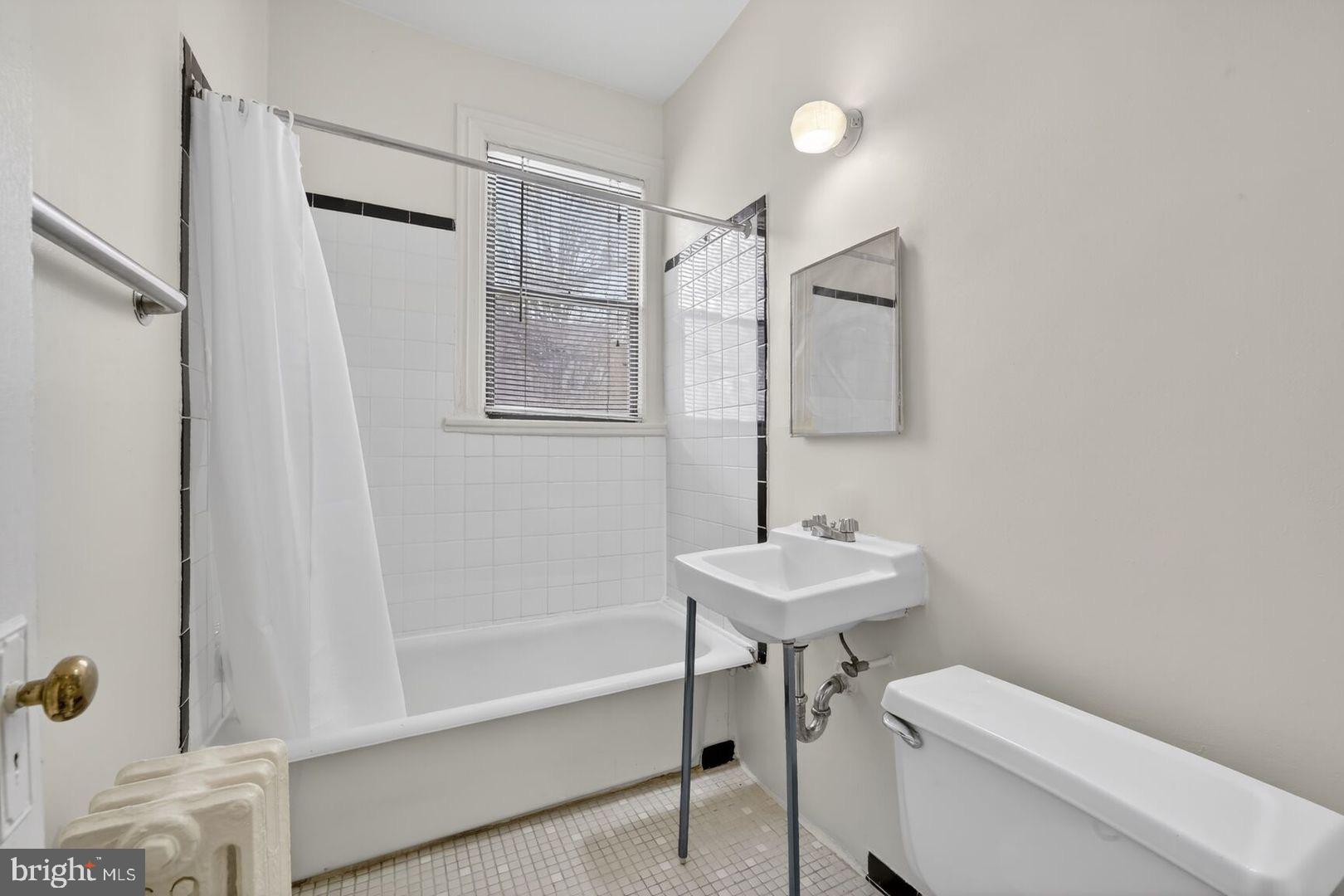 5400 7th Street Northwest, Unit 102 Washington, DC 20011 - Photo 7 of 7 a bathroom with a sink toilet and shower