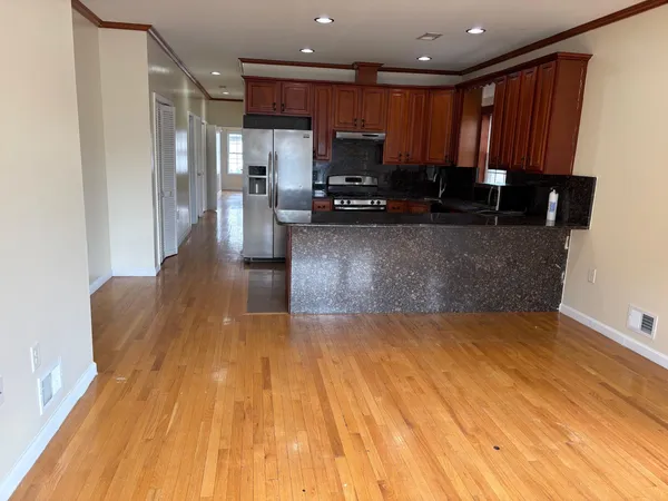 a kitchen with wooden floors and wooden cabinets