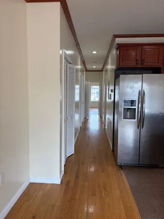 a view of a hallway with wooden floor