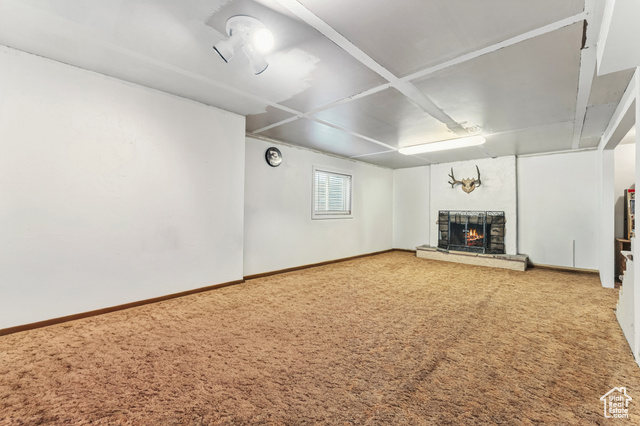 8843 Capernaum Road West Jordan, UT 84088 - Photo 18 of 31 Unfurnished living room featuring a fireplace and carpet flooring