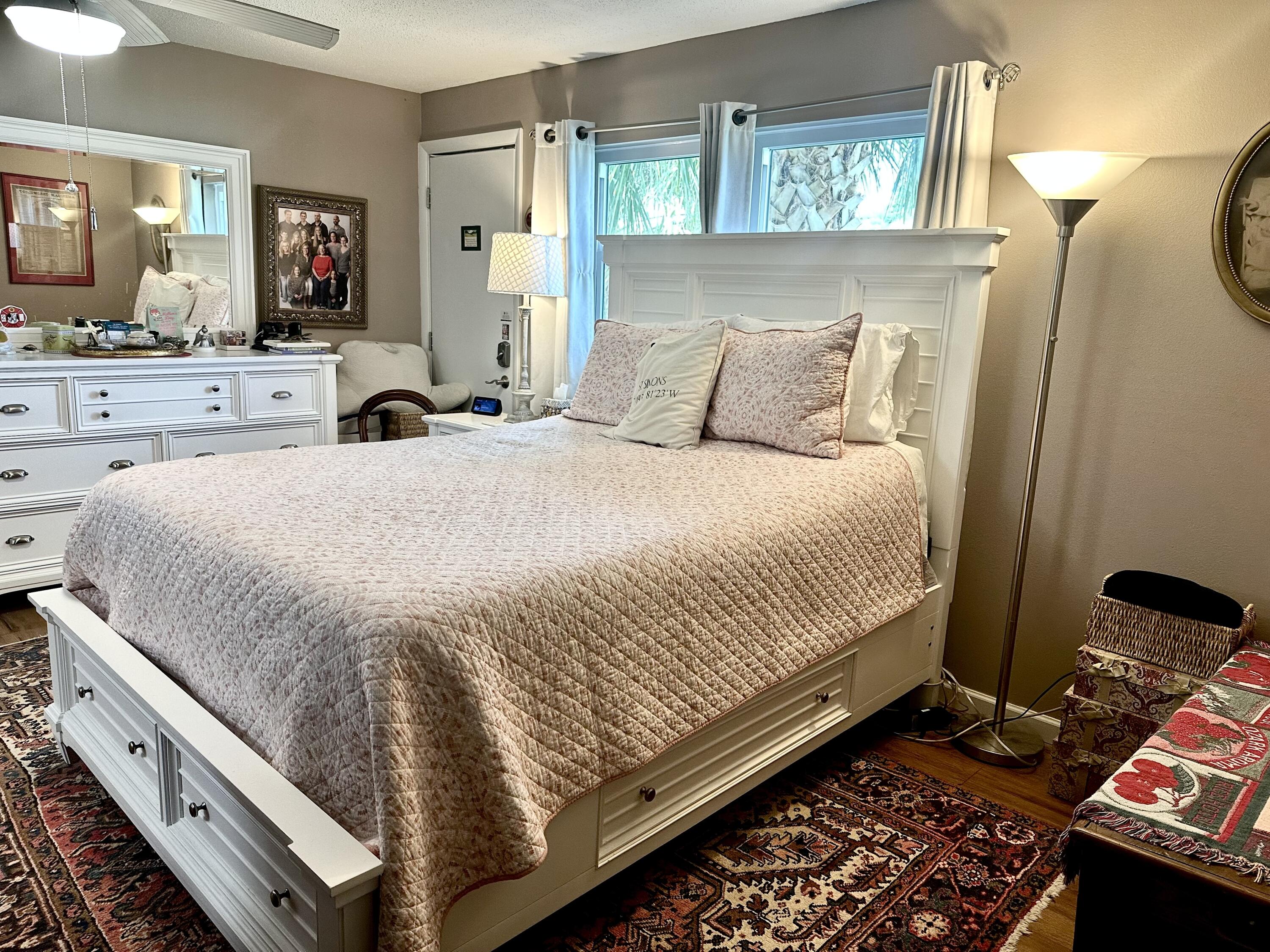 10821 North Military Trail, Unit 21 Palm Beach Gardens, FL 33410 - Photo 12 of 34 a spacious bedroom with a bed and window