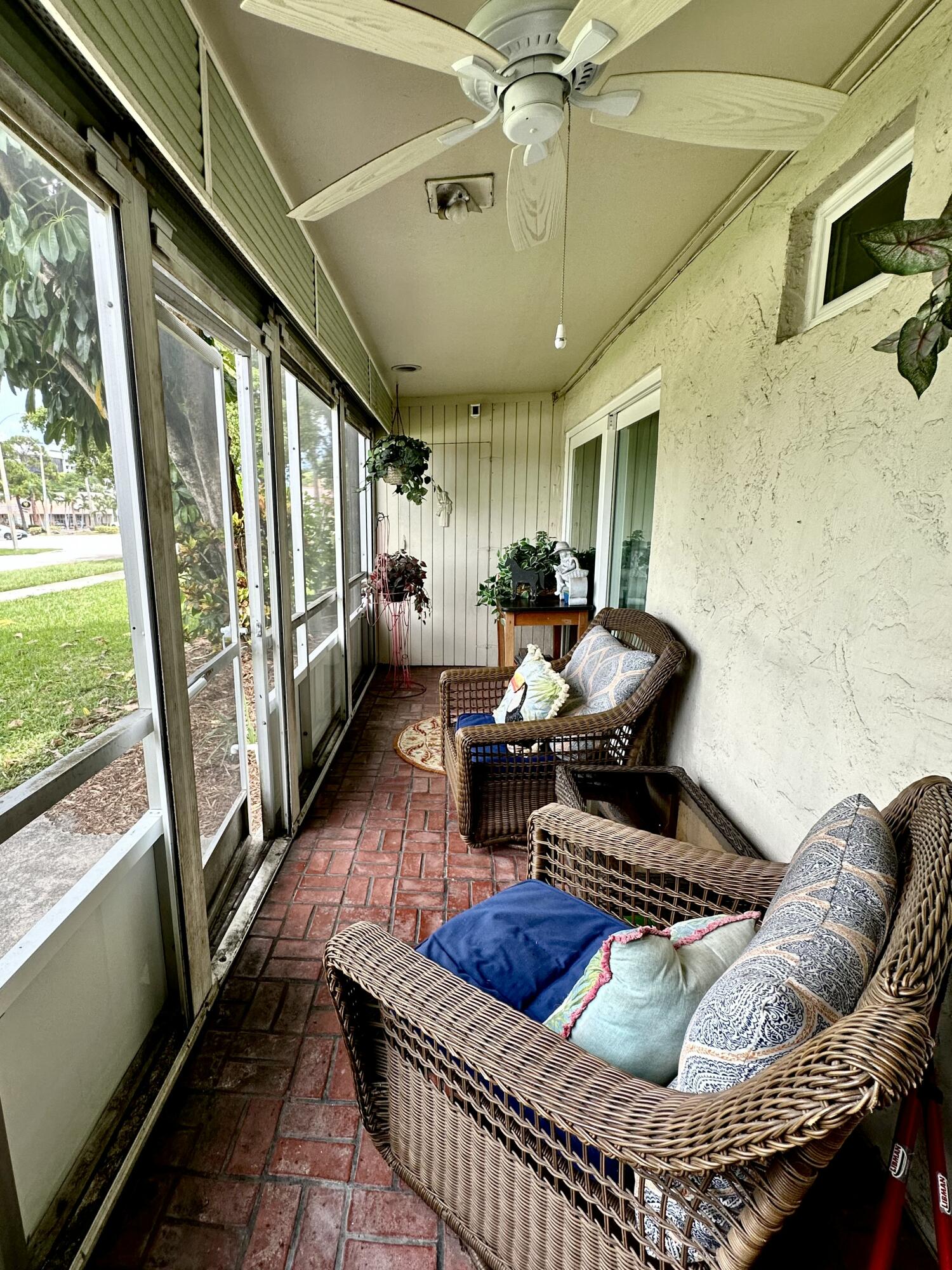10821 North Military Trail, Unit 21 Palm Beach Gardens, FL 33410 - Photo 31 of 34 a living room with furniture and a floor to ceiling window