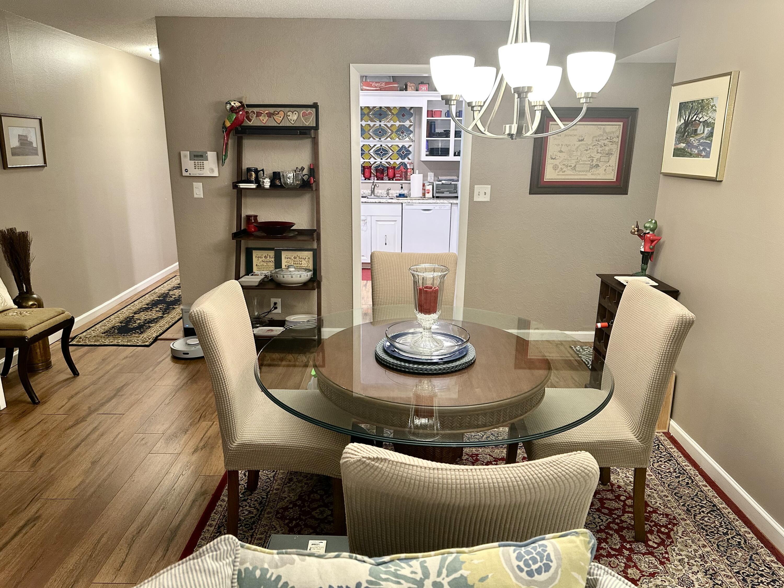 10821 North Military Trail, Unit 21 Palm Beach Gardens, FL 33410 - Photo 8 of 34 a living room with furniture and floor to ceiling window