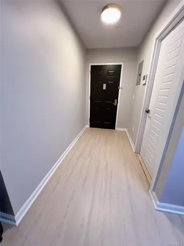 an empty room with wooden floor and white walls