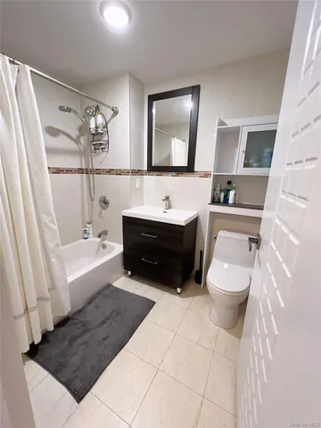 a bathroom with a sink a toilet and bathtub