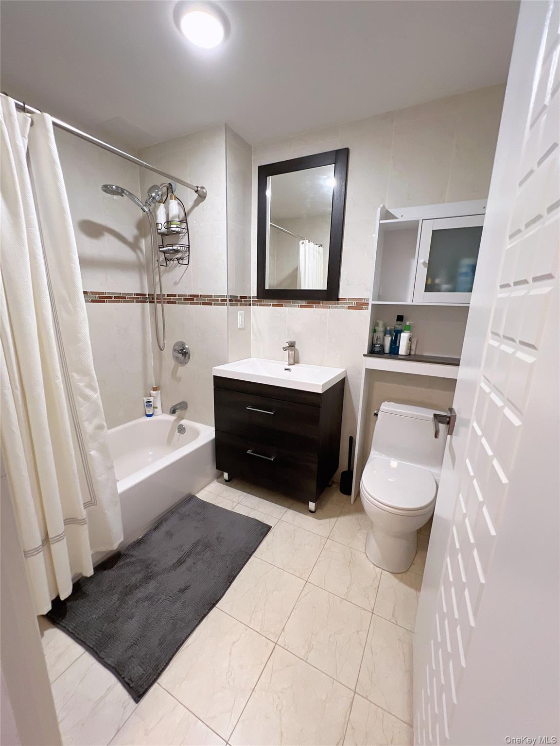 138-12 Northern Boulevard, Unit 3C Queens, NY 11354 - Photo 14 of 18 a bathroom with a sink a toilet and bathtub