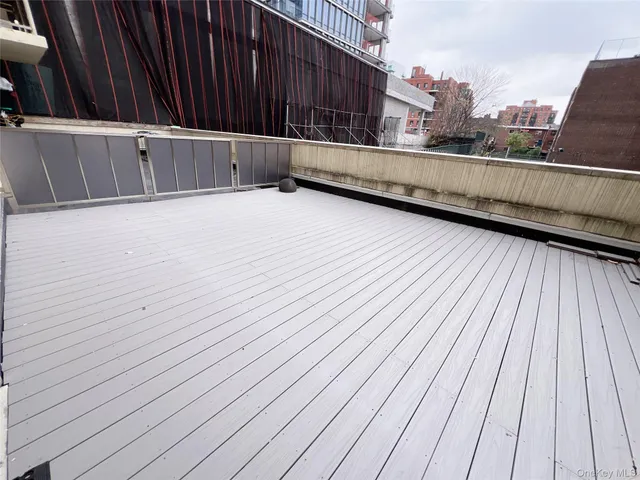 a view of a balcony with wooden floor
