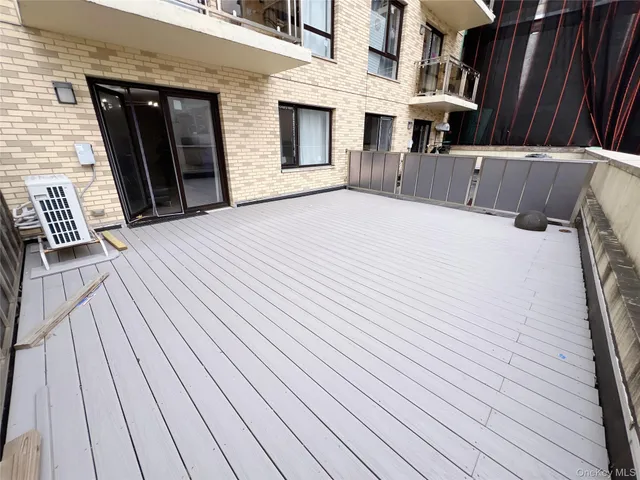 a view of a house with a barbeque and wooden floor