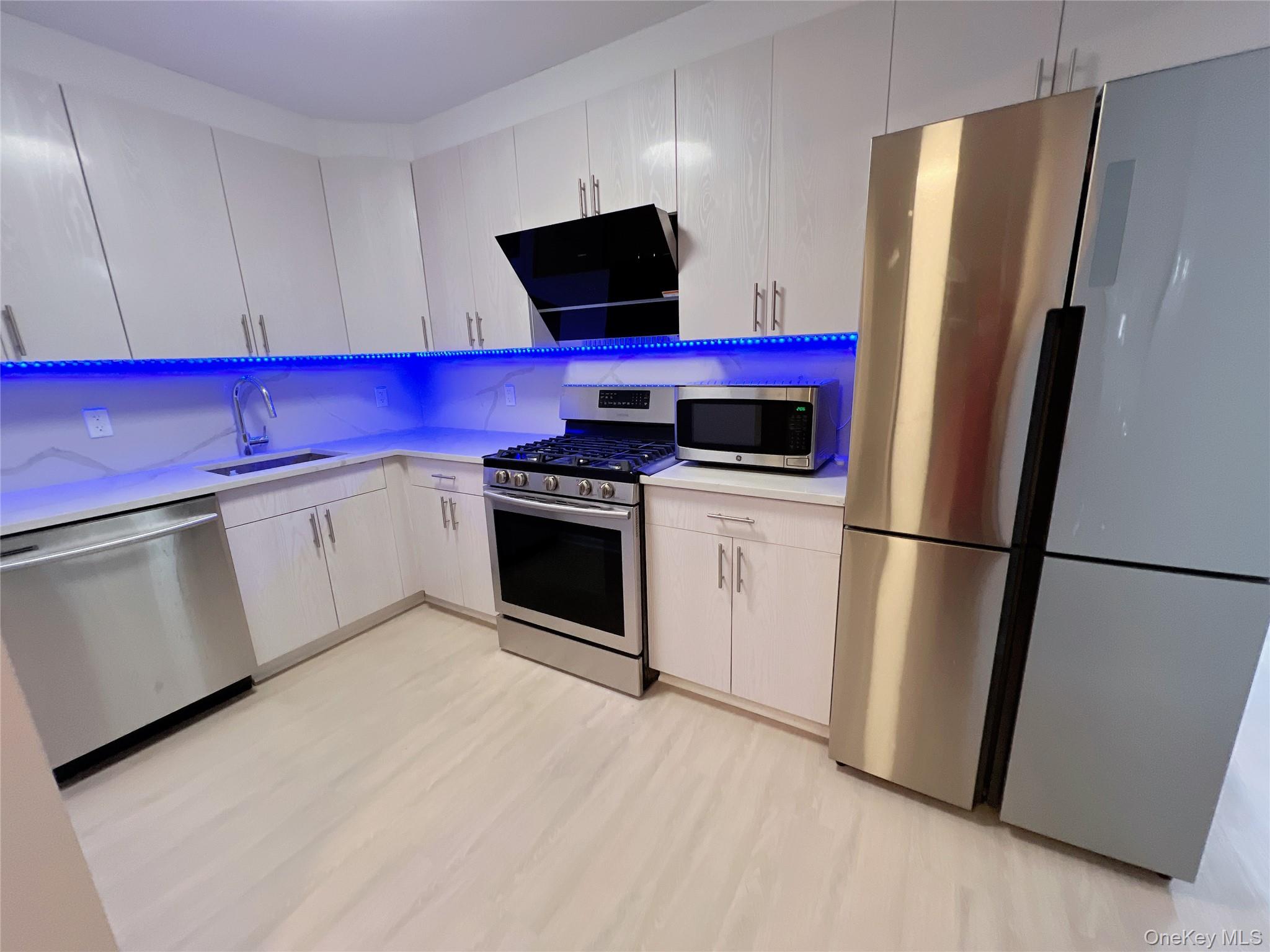 138-12 Northern Boulevard, Unit 3C Queens, NY 11354 - Photo 9 of 18 a kitchen with stainless steel appliances a refrigerator stove and microwave