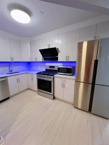 a kitchen with stainless steel appliances a stove a refrigerator and a sink