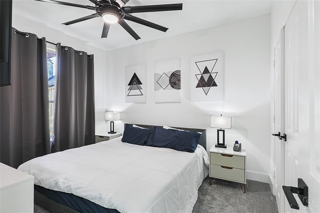 3805 Overlook Court The Colony, TX 75056 - Photo 11 of 29 a bedroom with a bed and a chandelier