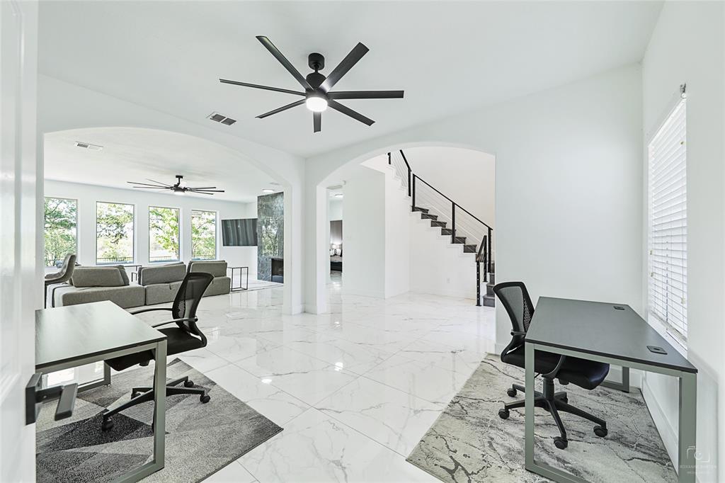 3805 Overlook Court The Colony, TX 75056 - Photo 12 of 29 a living room with a dining table and a ceiling fan