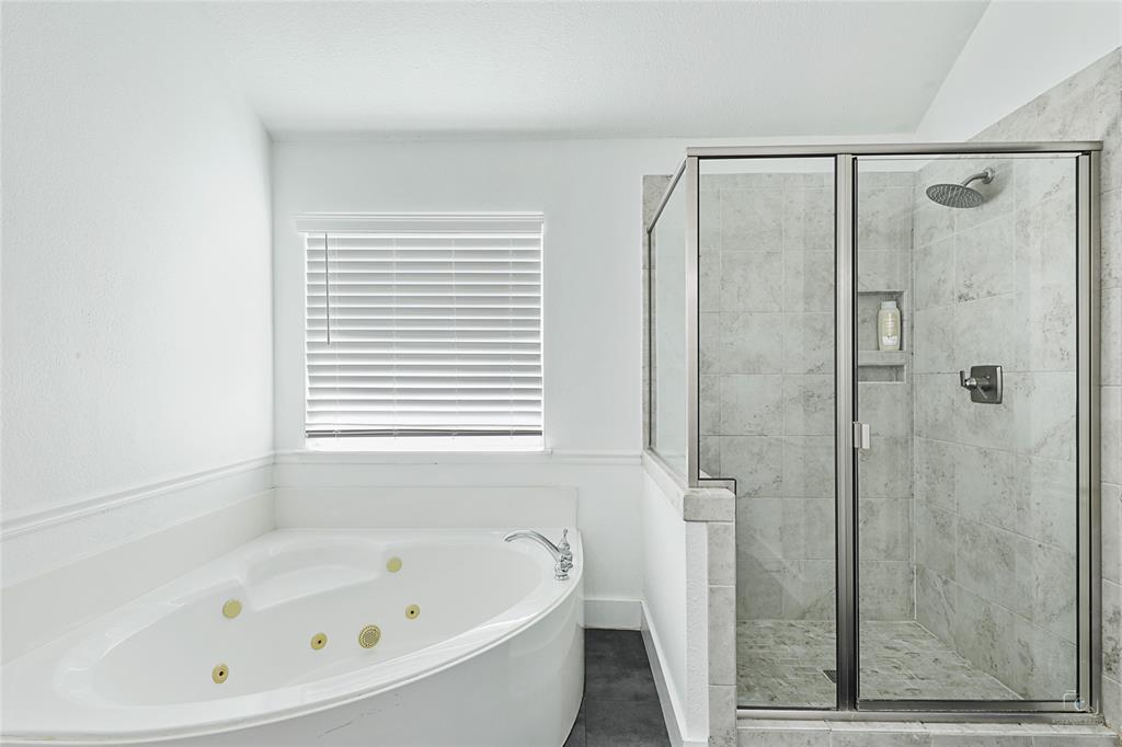 3805 Overlook Court The Colony, TX 75056 - Photo 18 of 29 a bathroom with a bathtub and shower