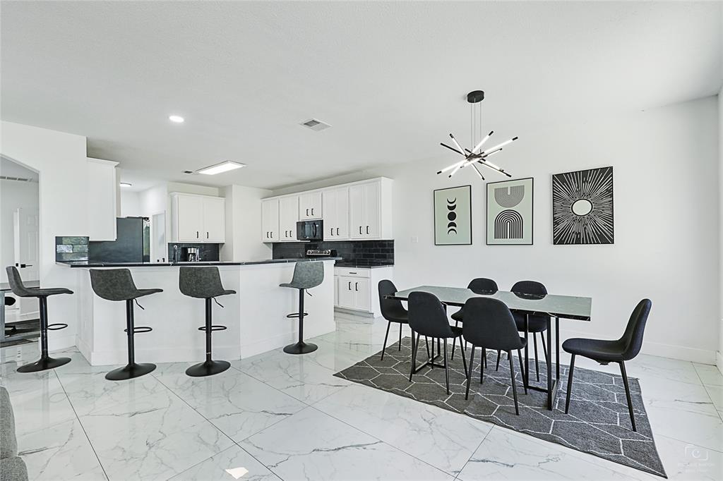 3805 Overlook Court The Colony, TX 75056 - Photo 22 of 29 a living room with furniture and kitchen view