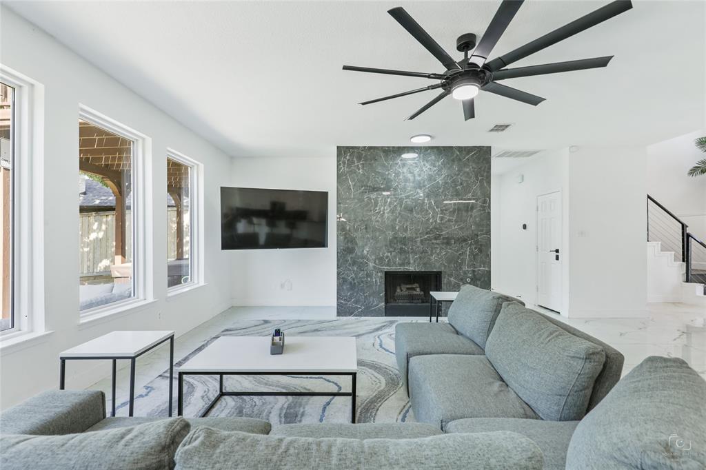 3805 Overlook Court The Colony, TX 75056 - Photo 26 of 29 a living room with furniture a flat screen tv and a fireplace