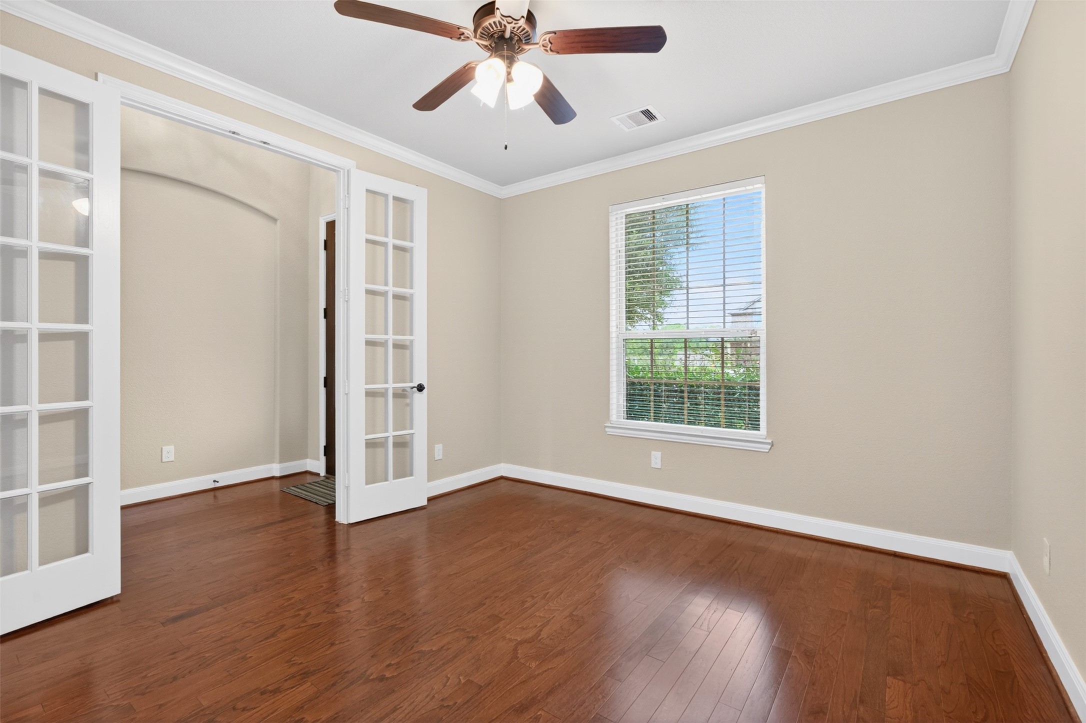 18202 Wedgewood Bluff Court Spring, TX 77379 - Photo 12 of 50 Private study with French doors, wood flooring, ceiling fan, and front-facing window.