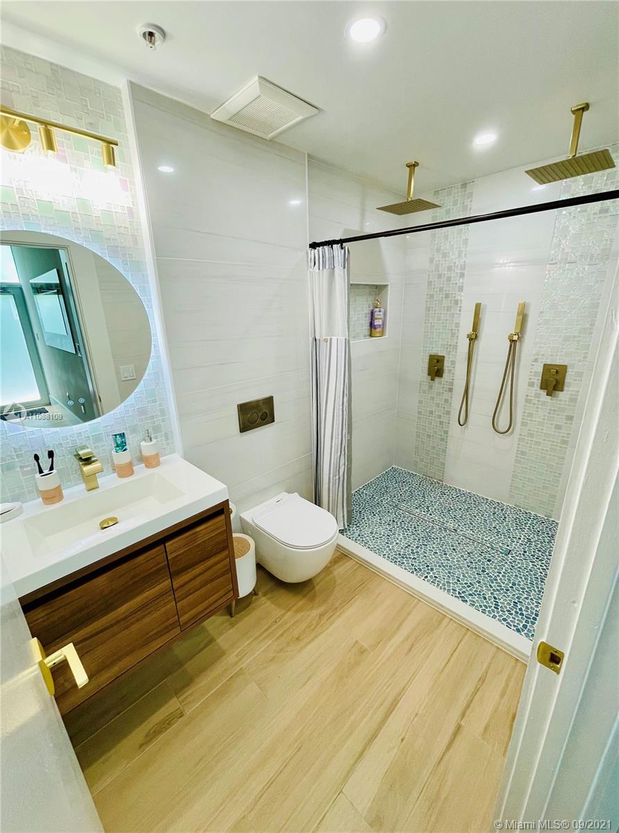 935 Euclid Avenue, Unit 5 Miami Beach, FL 33139 - Photo 12 of 27 a bathroom with a sink and a mirror