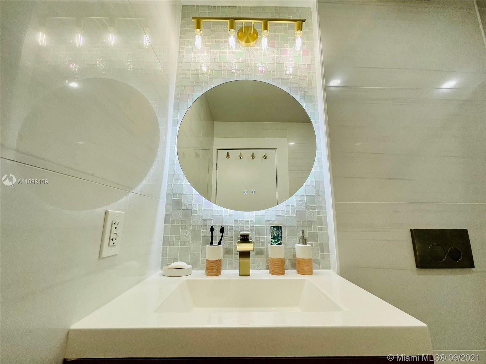 935 Euclid Avenue, Unit 5 Miami Beach, FL 33139 - Photo 13 of 27 a bathroom with a sink a mirror and a shower