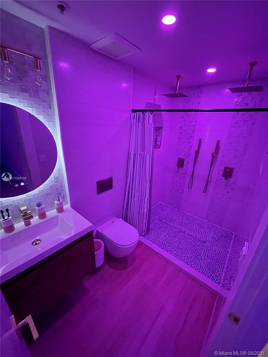 935 Euclid Avenue, Unit 5 Miami Beach, FL 33139 - Photo 16 of 27 a bathroom with a mirror and a toilet