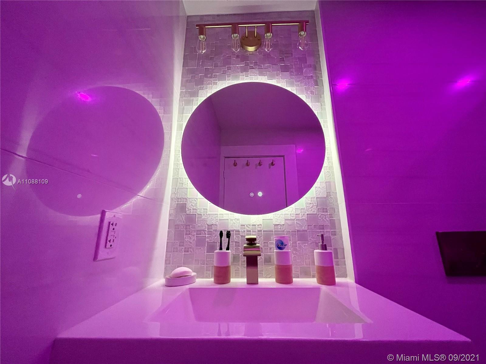 935 Euclid Avenue, Unit 5 Miami Beach, FL 33139 - Photo 17 of 27 a view of a pool with a dining room with chandelier and a fire place