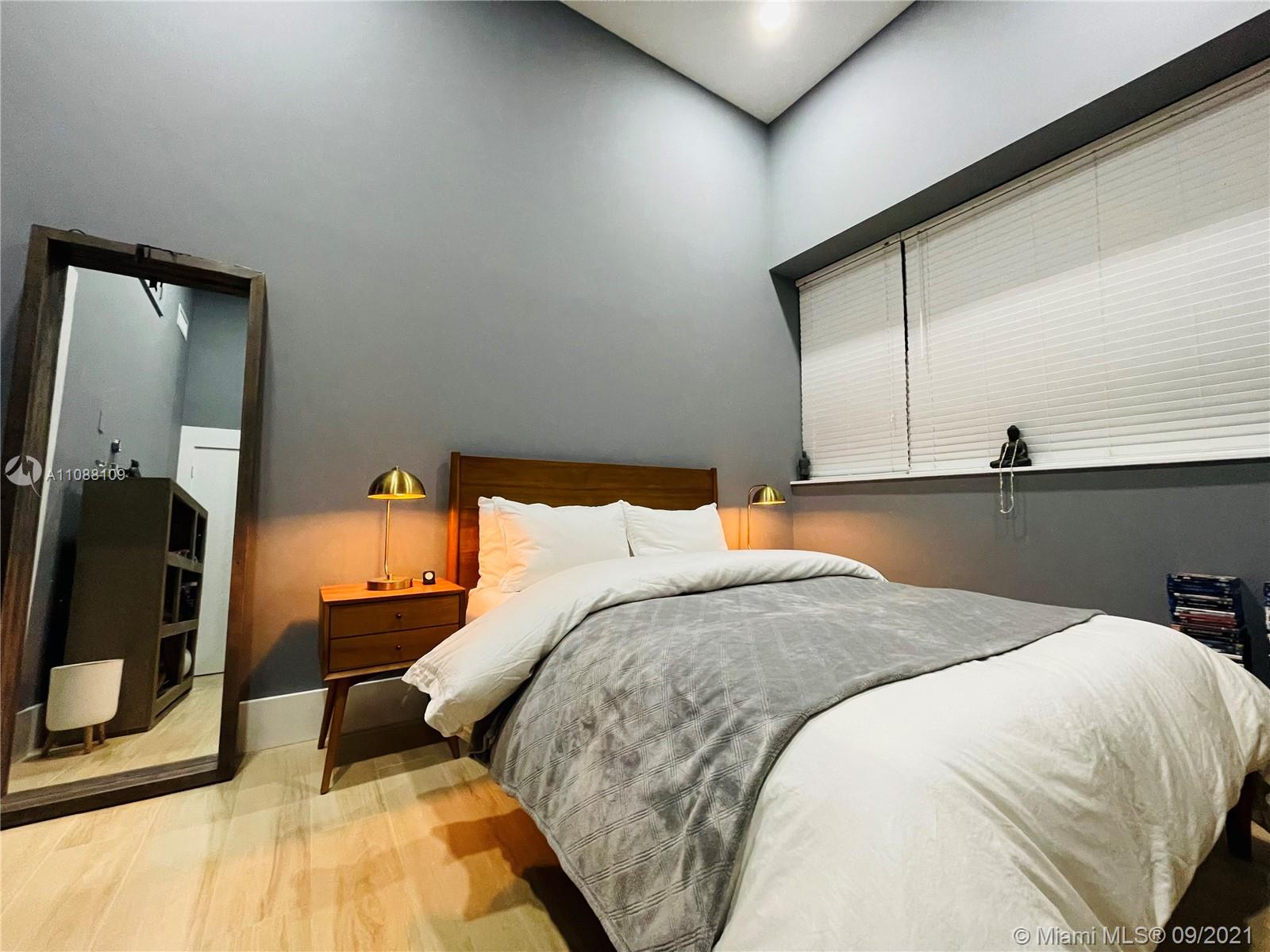 935 Euclid Avenue, Unit 5 Miami Beach, FL 33139 - Photo 20 of 27 a bed sitting in a bedroom next to a window