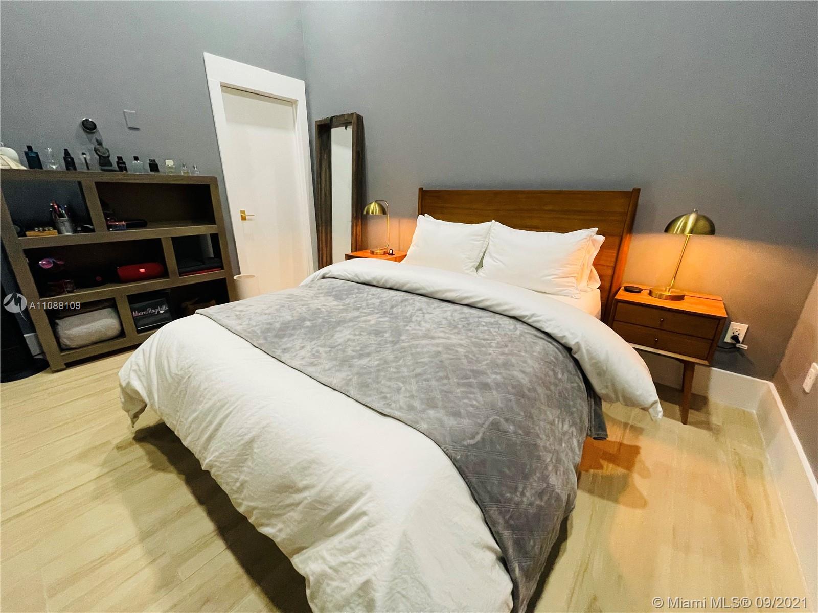 935 Euclid Avenue, Unit 5 Miami Beach, FL 33139 - Photo 21 of 27 a large bed sitting in a bedroom next to a window