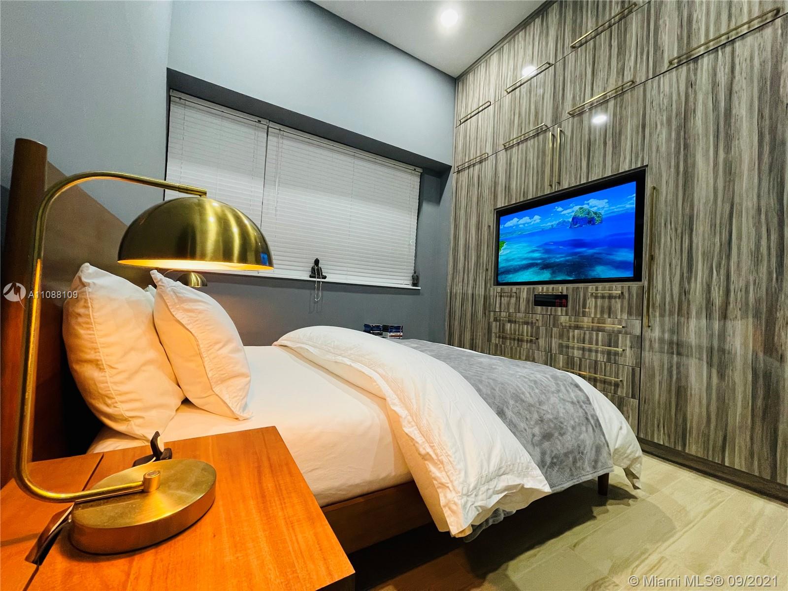 935 Euclid Avenue, Unit 5 Miami Beach, FL 33139 - Photo 22 of 27 a bedroom with a bed and dresser