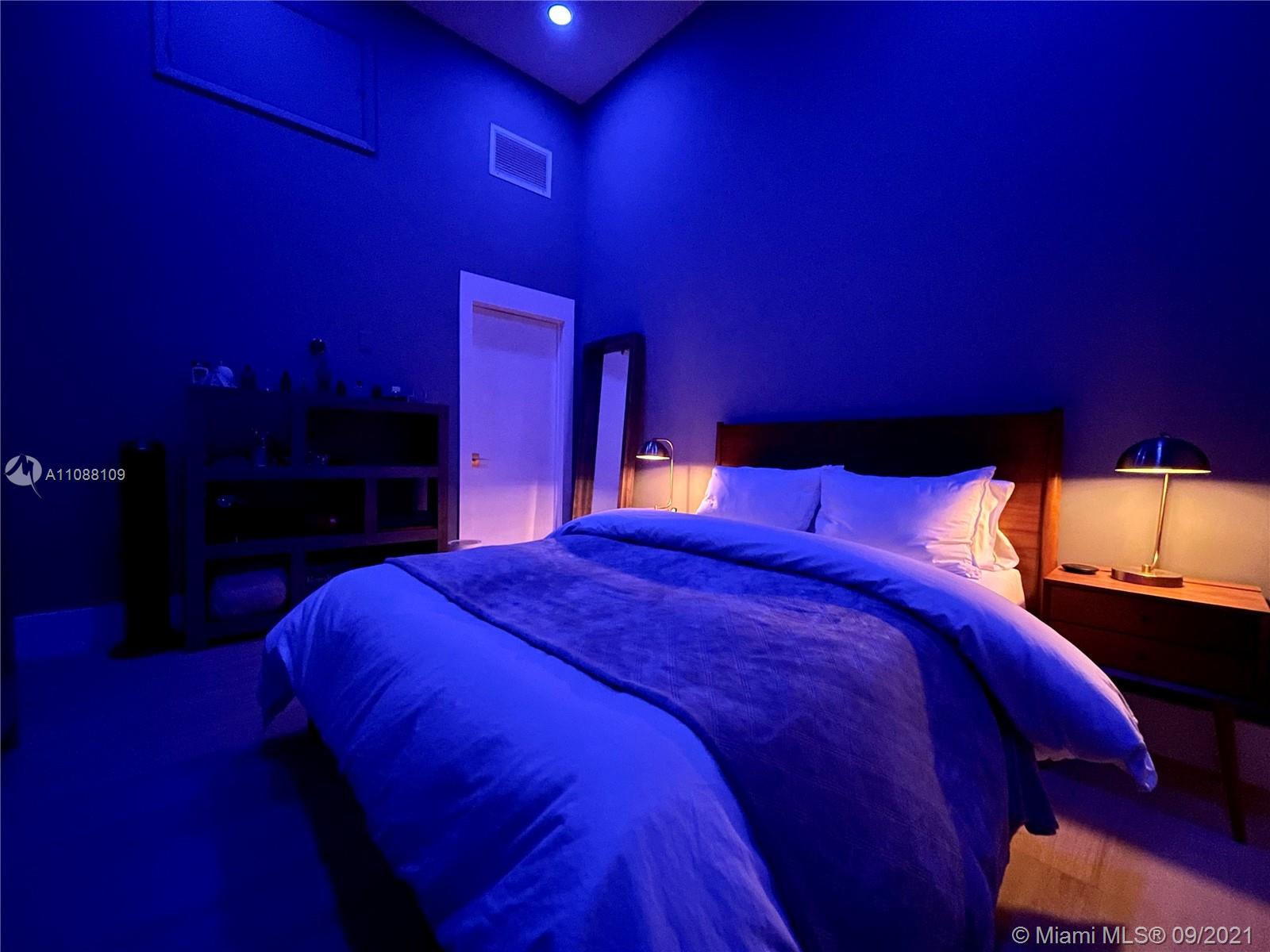 935 Euclid Avenue, Unit 5 Miami Beach, FL 33139 - Photo 24 of 27 a large bed with a mirror