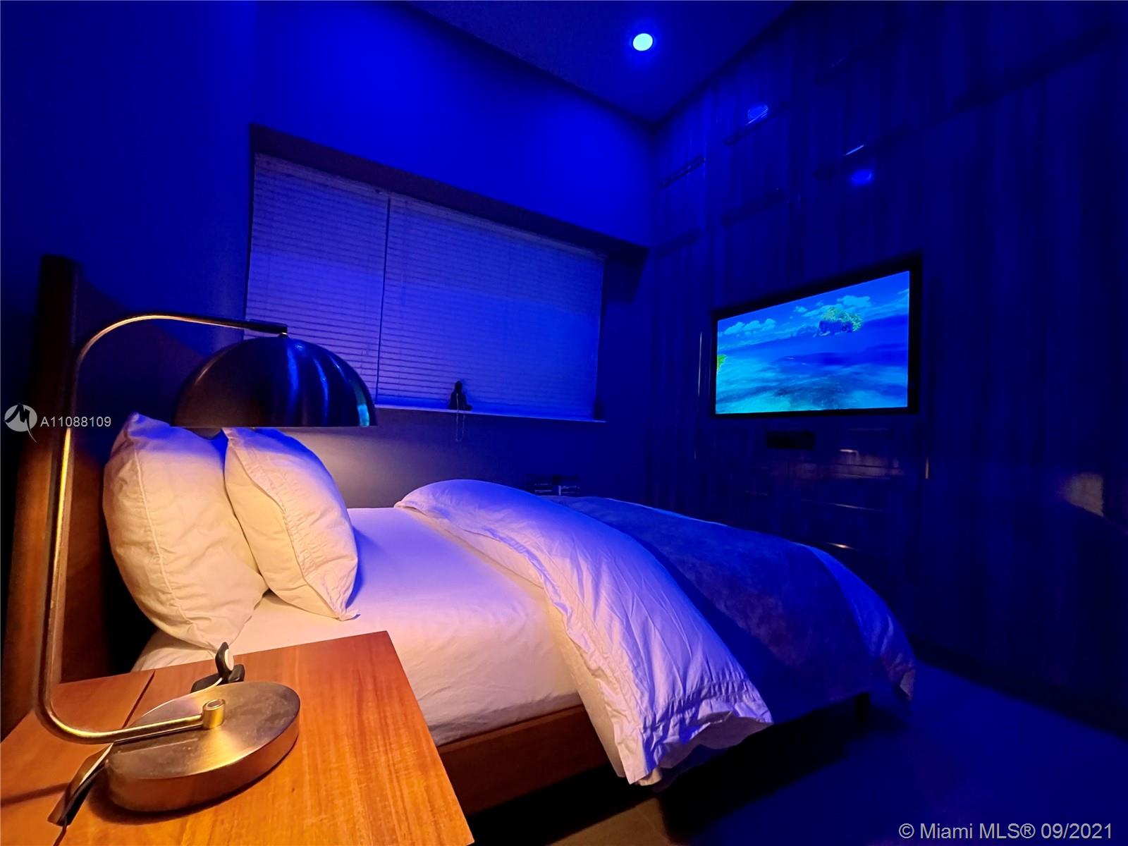 935 Euclid Avenue, Unit 5 Miami Beach, FL 33139 - Photo 25 of 27 a bedroom with a bed and a mirror