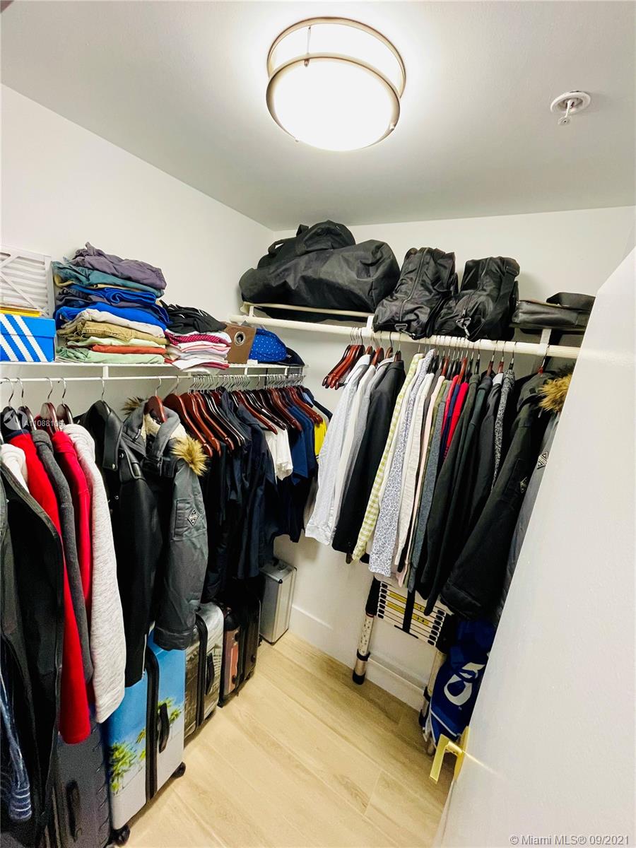 935 Euclid Avenue, Unit 5 Miami Beach, FL 33139 - Photo 26 of 27 a view of walk in closet with clothes and shoes