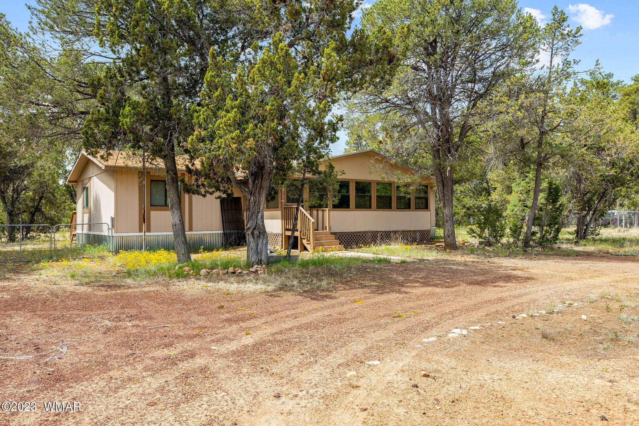 3067 Ponderosa Road Overgaard, AZ 85933 - Photo 1 of 32 a view of a house with a backyard and a tree