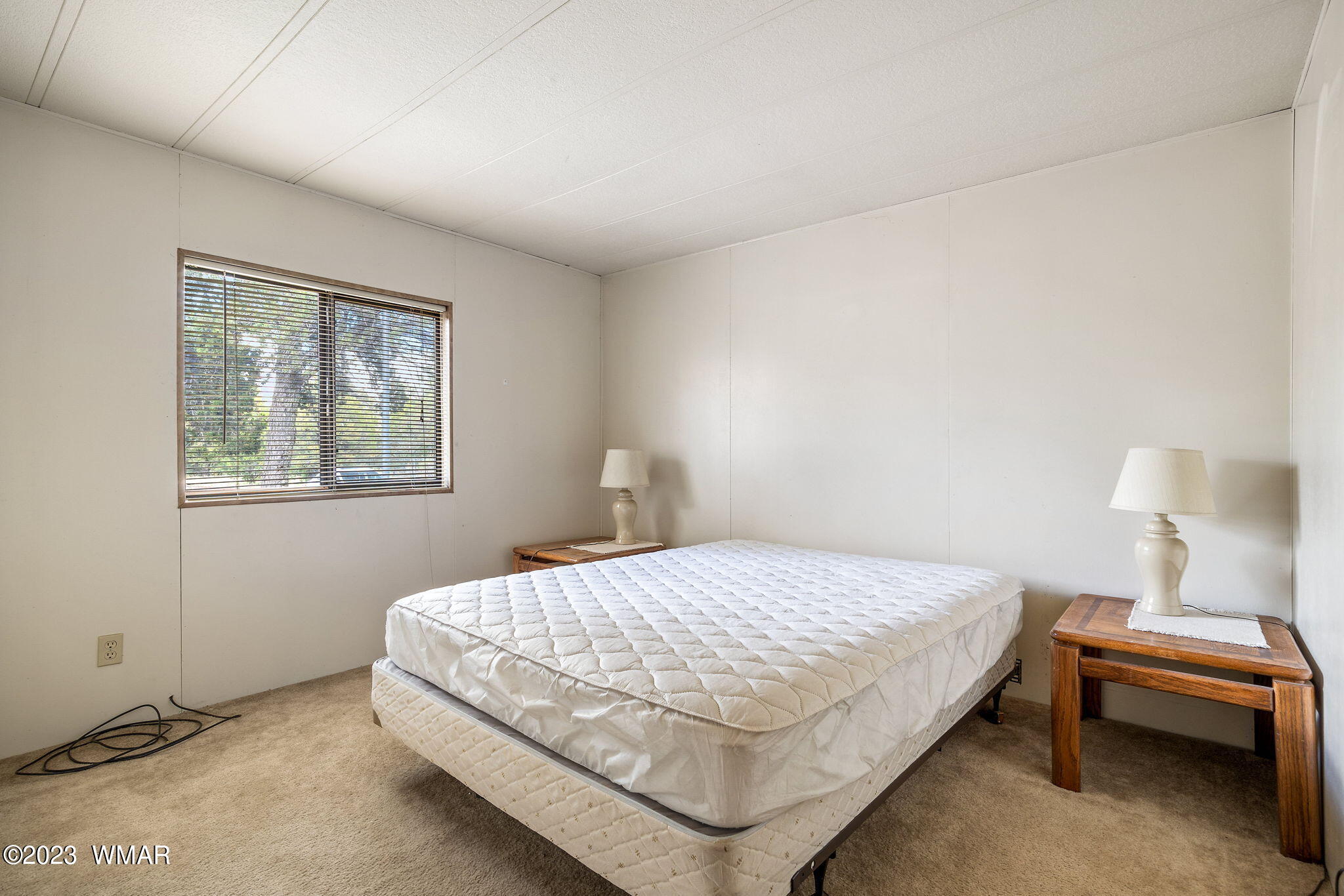 3067 Ponderosa Road Overgaard, AZ 85933 - Photo 21 of 32 a bedroom with a bed and a window