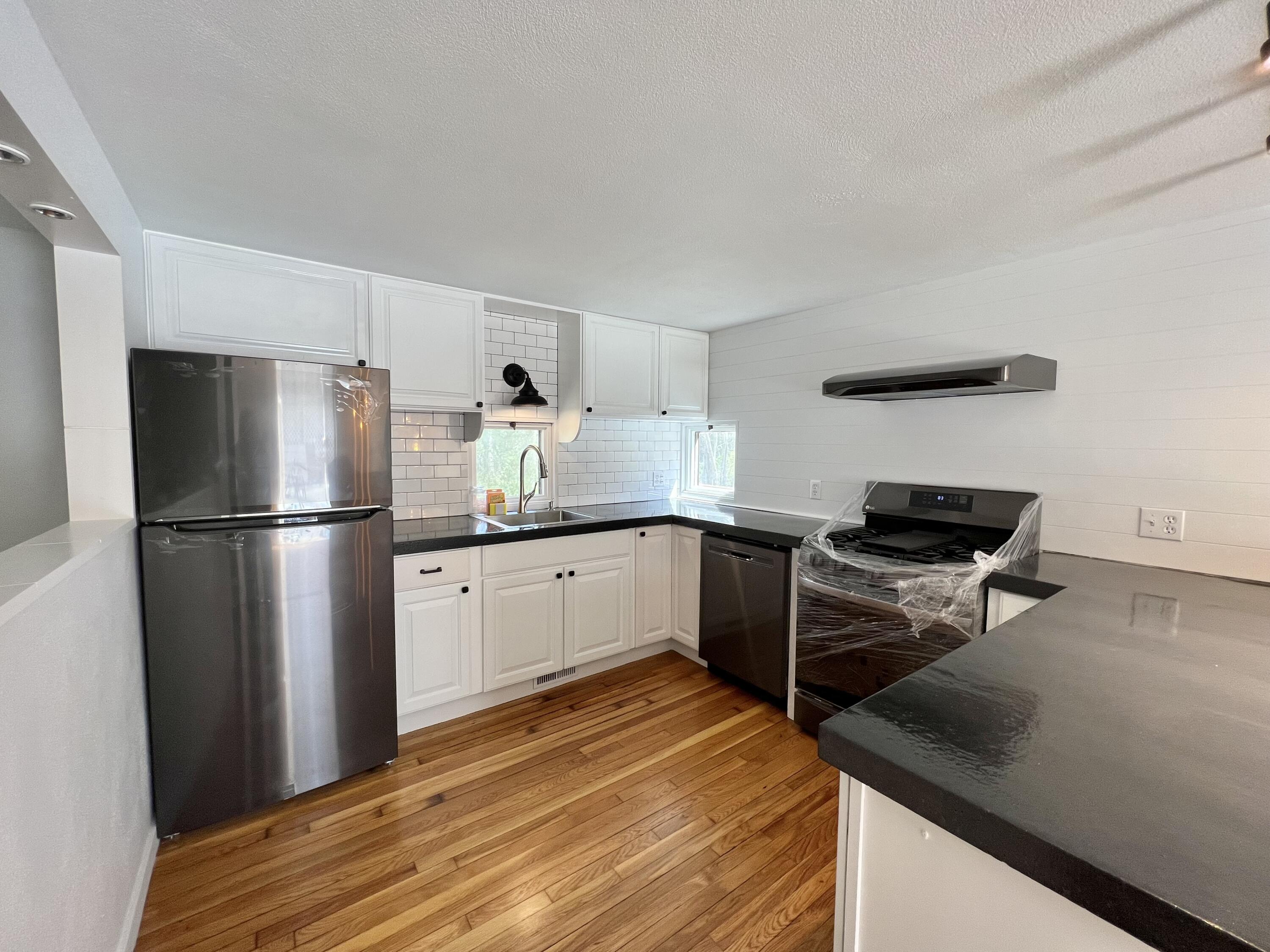 10 Freedom Road, Unit 10 Forestdale, MA 02644 - Photo 3 of 27 a kitchen with a refrigerator and a stove top oven