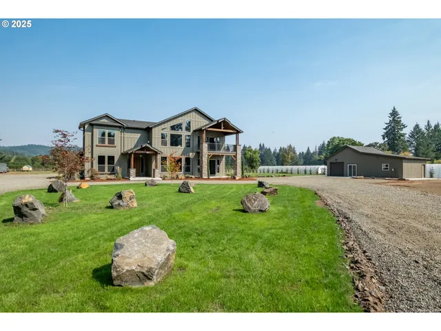 a front view of a house with a yard table and chairs
