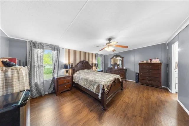 a bedroom with a bed closet and a window