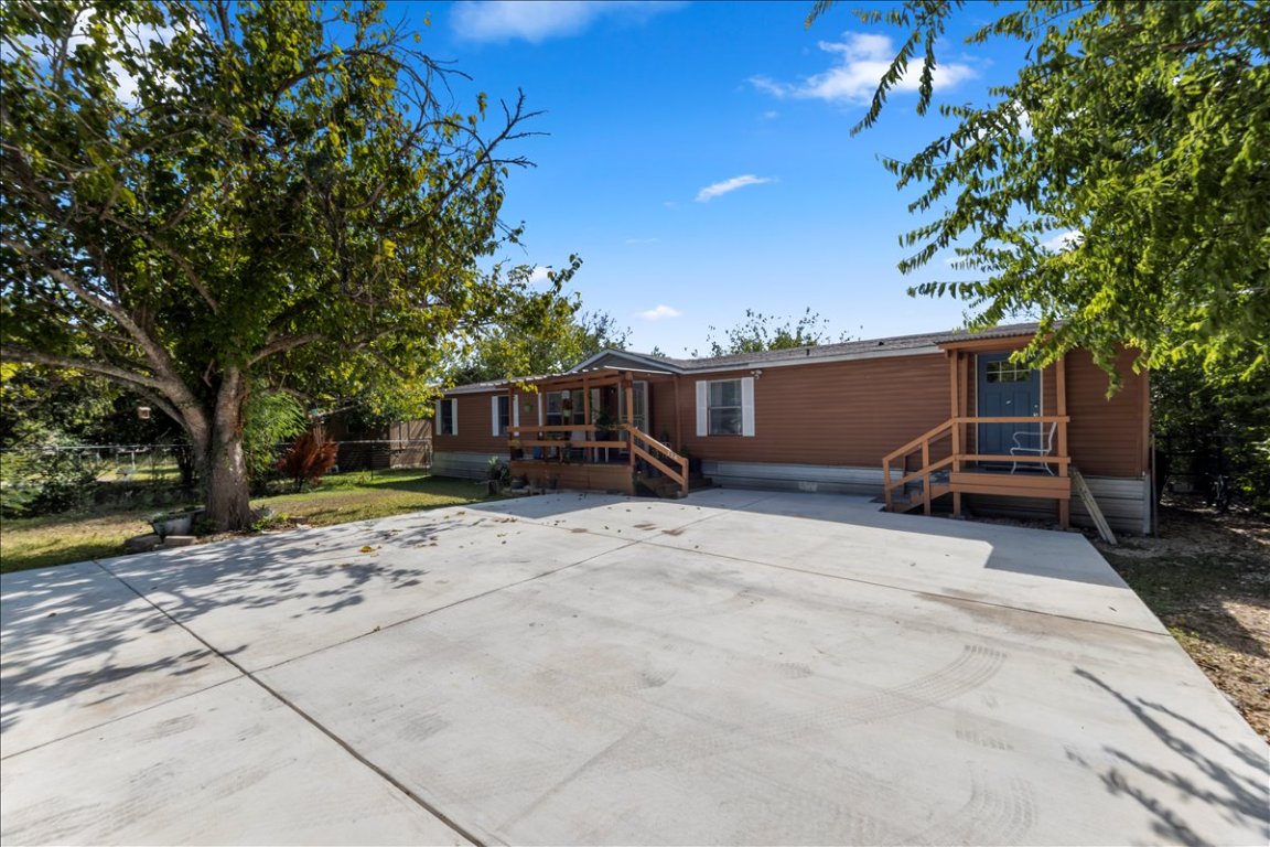 114 Dove Lane Kyle, TX 78640 - Photo 2 of 24 a view of a house with backyard and a tree