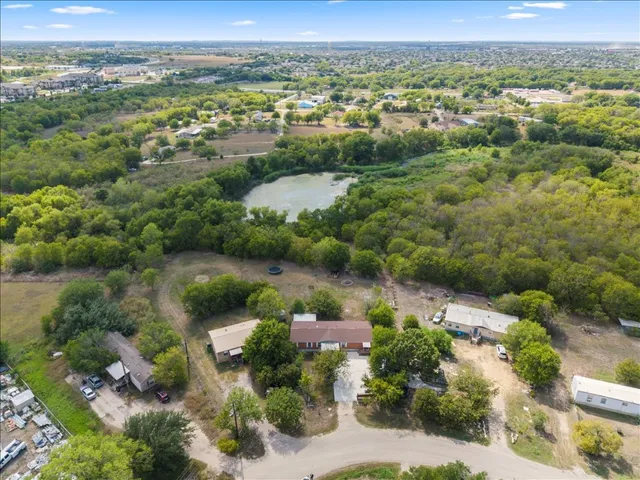 an aerial view of mountain with residential house and lake view