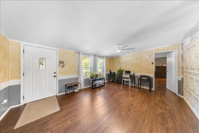a view of a livingroom with furniture and hardwood floor