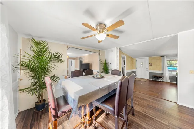 a view of a dining room with furniture and a potted plant