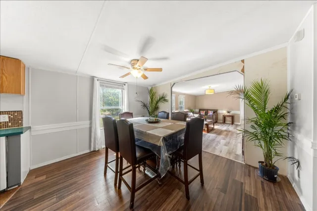 a view of a dining room with furniture window and wooden floor