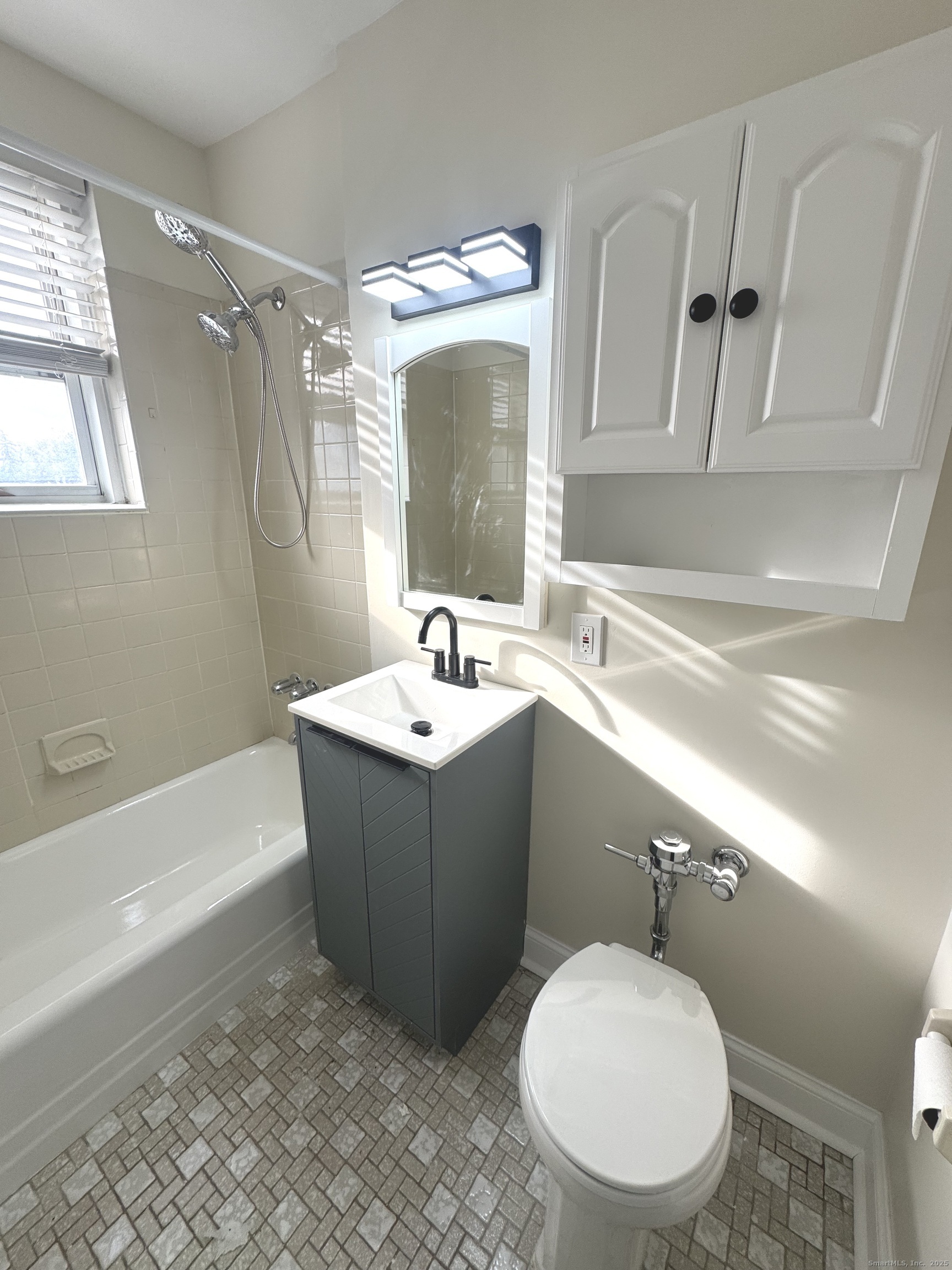 45 Maple Street, Unit 2E Norwalk, CT 06850 - Photo 13 of 16 a bathroom with a sink mirror vanity and toilet