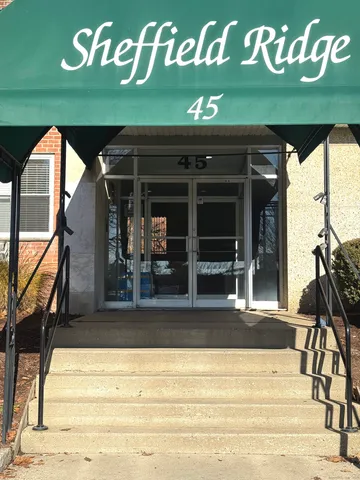 a front view of a building with a sign board
